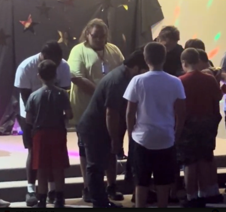 Worship moment at Greater Camp